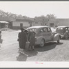 Loading baggage of train passenger into automobile. Montrose, Colorado