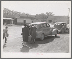 Loading baggage of train passenger into automobile. Montrose, Colorado