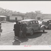 Loading baggage of train passenger into automobile. Montrose, Colorado