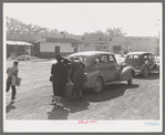 Loading baggage of train passenger into automobile. Montrose, Colorado