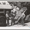 Chairman of Cornish machinery cooperative handing over check to dealer in payment of ensilage harvester. Preston, Idaho