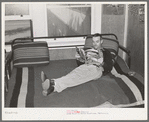 Worker in bunkhouse room at the Earl Fruit Company ranch. Kern County, California