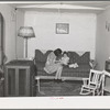 Interior of living room of married couple living in remodeled boxcar. Earl Fruit Company ranch. Kern County, California