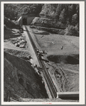 Many miles of the Southern Pacific railroad had to be enrouted and new tunnels and track constructed to take care of impounding of water by Shasta Dam. Shasta County, California