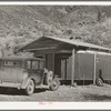 Home of construction worker at Shasta Dam. Summit City, California. Notice that the trailer has been incorporated into the house