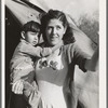 Mother and child in front of tent-home. This family is from Oregon. The man is a concrete worker. Mission Valley, California, which is about three miles from San Diego