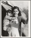 Mother and child in front of tent-home. This family is from Oregon. The man is a concrete worker. Mission Valley, California, which is about three miles from San Diego