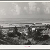 Workers' automobiles parked near the airplane factories. San Diego, California. Providing parking space for automobiles and getting the cars in and out at shift changing time have been big problems