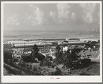 Workers' automobiles parked near the airplane factories. San Diego, California. Providing parking space for automobiles and getting the cars in and out at shift changing time have been big problems