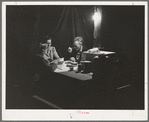 Carpenter, his wife and daughter eating supper in front of their tent-home. Mission Valley, California, about three miles from San Diego
