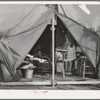 Construction worker's wife ironing in her tent home. Mission Valley, California, about three miles from San Diego