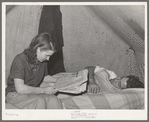 Concrete worker resting while his wife looks for apartments in the want ads. He works the night shift. They have been unable to find a reasonably priced apartment and are living in a tent. They are from Washington. Pacific Beach, California