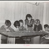 Six children of carpenter from Hobbs, New Mexico, reading the funny papers. This family of eight are living in two small rooms in tourist court because they can find nothing larger at a reasonable price. Corpus Christi, Texas