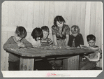 Six children of carpenter from Hobbs, New Mexico, reading the funny papers. This family of eight are living in two small rooms in tourist court because they can find nothing larger at a reasonable price. Corpus Christi, Texas