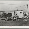 Automobile and trailer parked in trailer court. These belong to a carpenter's helper who is from the Rio Grande Valley. He owns his home in the valley, has done farm work and public work there. His family is with him in Corpus Christi where he is now working at the naval air base