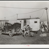 Automobile and trailer parked in trailer court. These belong to a carpenter's helper who is from the Rio Grande Valley. He owns his home in the valley, has done farm work and public work there. His family is with him in Corpus Christi where he is now working at the naval air base