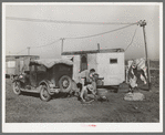 Automobile and trailer parked in trailer court. These belong to a carpenter's helper who is from the Rio Grande Valley. He owns his home in the valley, has done farm work and public work there. His family is with him in Corpus Christi where he is now working at the naval air base