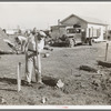 Man working on foundation for new house in cheap residential section of Corpus Christi, Texas. Many cheap houses are now being built to satisfy the demand of workmen and their families for housing