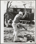 Truck driver repairing tire. Corpus Christi, Texas