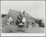 Roofer and his daughter in front of tent home. Corpus Christi, Texas. This man has been working at the naval air training base but hurt his back a week ago and is now unable to work