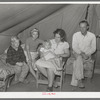 Family of roofer from Oklahoma in their tent home at Corpus Christi, Texas. He is working at the naval air training base. He draws one dollar an hour pay but frequent layoffs because of bad weather makes his average weekly wage small