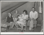 Family of roofer from Oklahoma in their tent home at Corpus Christi, Texas. He is working at the naval air training base. He draws one dollar an hour pay but frequent layoffs because of bad weather makes his average weekly wage small