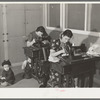 Wives of farm workers living at the Yuba City FSA camp sewing in the community building of the camp. Yuba City, California