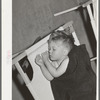 Boy asleep in community building of the Yuba City farm workers' camp. Yuba City, California