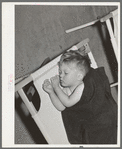 Boy asleep in community building of the Yuba City farm workers' camp. Yuba City, California