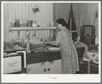 Wife of farmer in her kitchen. Auburn, California. Notice the electric stove, running water and radio. Electrification has been general in this section for twenty years