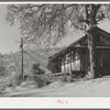 Farm house with orchards in the background near Auburn, California. Farmers haven't had much money in this section to repair houses in the last ten years