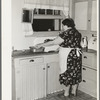 Wife of fruit farmer at her kitchen sink. Placer County, California