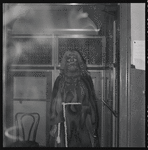 Set piece of a monk sitting in an elevator backstage