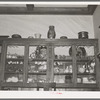 China cabinet in home of fruit farmer. Placer County, California. These fruit specialists have had a high standard of living, are now losing their farms