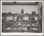 China cabinet in home of fruit farmer. Placer County, California. These fruit specialists have had a high standard of living, are now losing their farms
