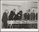 Members of the Loomis Fruit Association cooperative sitting down to dinner after their fortieth annual meeting. Loomis, California