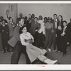 Negro swinging his girl on roller skates. Savoy Ballroom, Chicago, Illinois