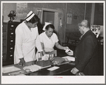 Clinic patient receiving instruction card at municipal tuberculosis sanitarium. Chicago, Illinois