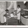 Preparing milk for baby. Family is on relief. Chicago, Illinois