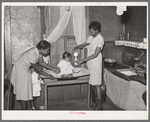 Preparing milk for baby. Family is on relief. Chicago, Illinois