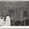 Some of the members of the Pentecostal church with crutches and canes deposited in the church by those who have been healed by the church. Chicago, Illinois