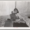 Little boy putting on his shoes. Chicago, Illinois