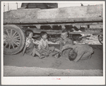 Children playing under wagon at the Schroder farm, FSA (Farm Security Administration) rehabilitation borrowers living on Dead Ox Flat. Vale-Owyhee irrigation project, Malheur County, Oregon