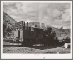 Locomotive of logging train. Baker County, Oregon. There has been a tendency to change from the logging train to trucks to transport logs to mills during recent years