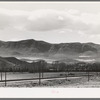 Fields extending into the mountains. Henefer, Utah. Mormon farmers in this section not only practice irrigation but take advantage of as much of all natural runoff from the mountains as possible