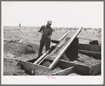 Mr. Browning screening coal which he has salvaged. He will burn the larger lumps. He is an FSA  rehabilitation borrower living at Dead Ox Flat, Malheur County, Oregon