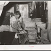 Mrs. Free, wife of FSA (Farm Security Administration) rehabilitation borrower, with incubator in her basement house. Dead Ox Flat, Oregon