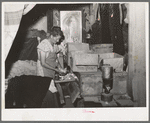 Mrs. Free, wife of FSA (Farm Security Administration) rehabilitation borrower, with incubator in her basement house. Dead Ox Flat, Oregon