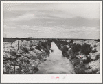 Irrigation lateral ditch to provide water for farms on the Vale-Owyhee irrigation project. Notice that the piles of dirt on the sides give some indication of the relative newness of this project. Malheur County, Oregon