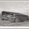 Shed on farm of Mr. White, FSA (Farm Security Administration) rehabilitation borrower. Dead Ox Flat. Corn stalks are used on north wall of the shed for protection